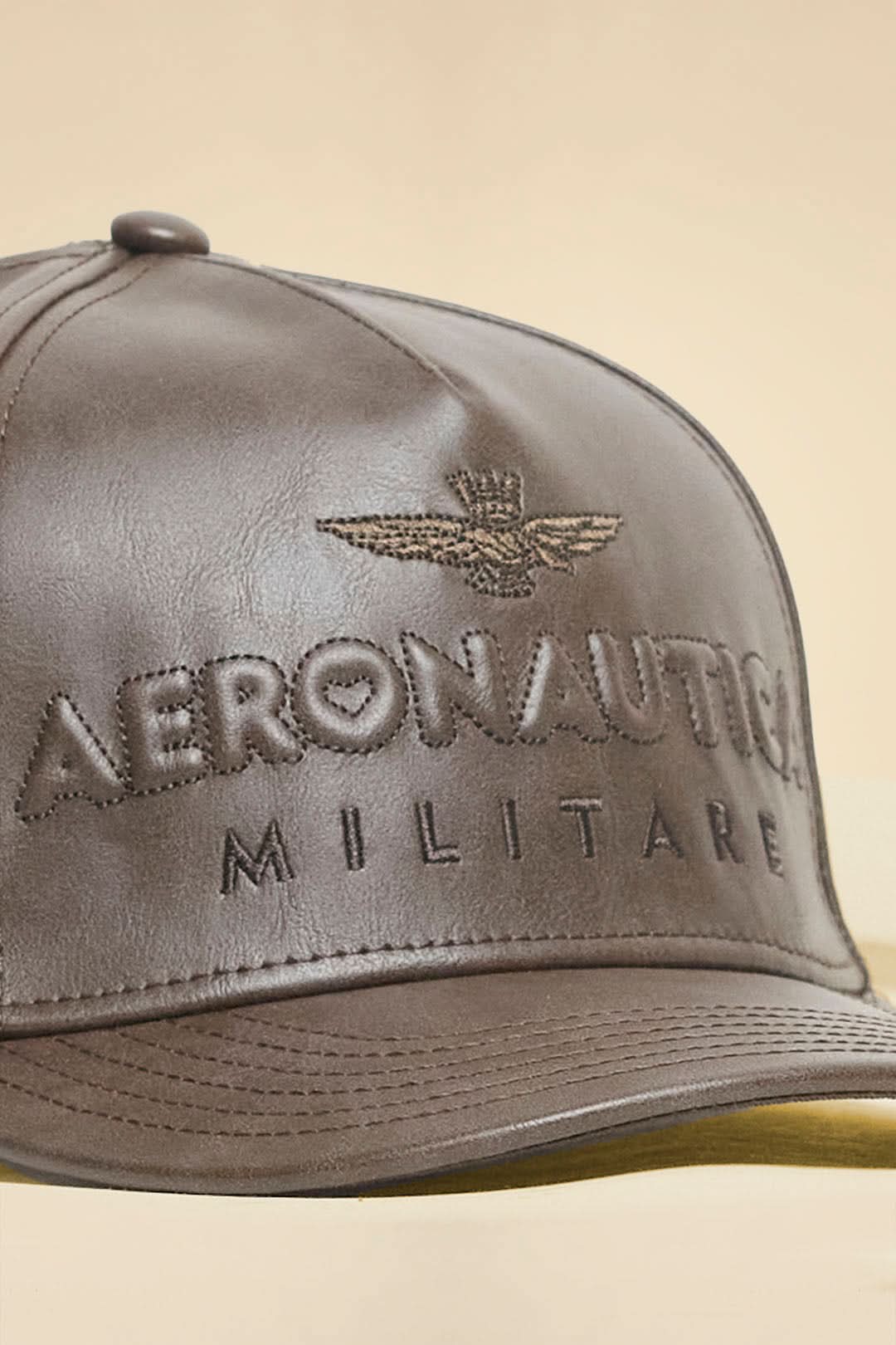 Brown eco-leather cap with logo